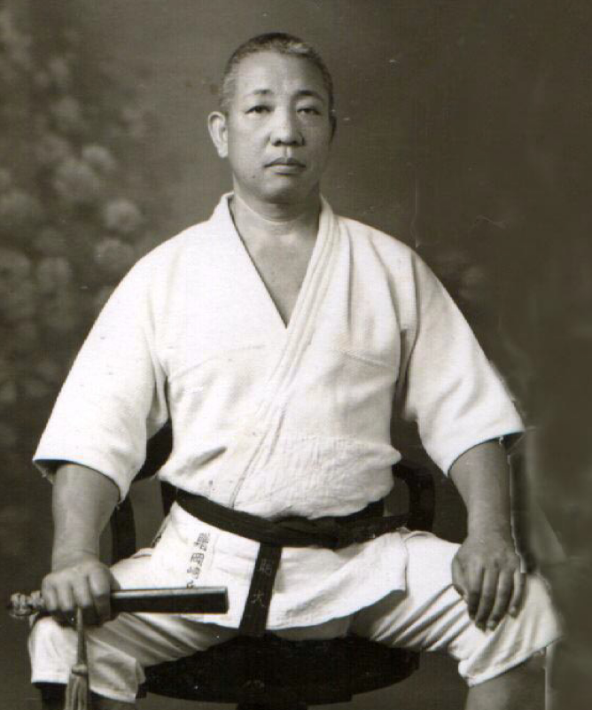 Prof Okazaki seated in gi with his tessem